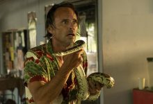 Walton Goggins sebagai Rick Hatchett memegang ular di lotus putih musim 3