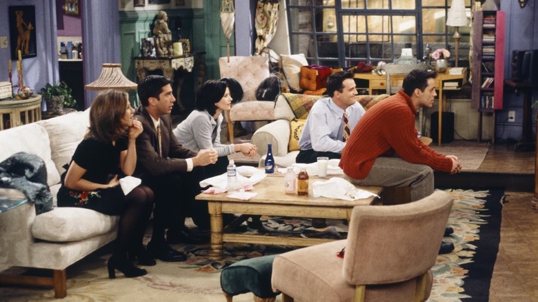 Jennifer Aniston sebagai Rachel, David Schwimmer sebagai Ross, Courtney Cox sebagai Monica, Matthew Perry sebagai Chandler dan Matt LeBlanc sebagai Joey terpaku pada televisi di Friends