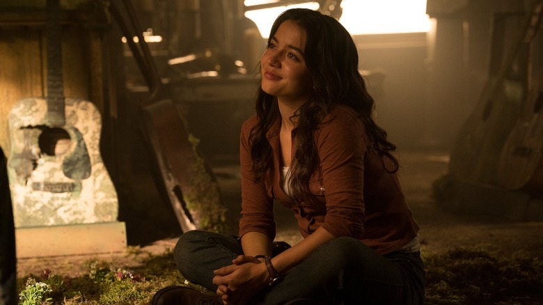 Dina duduk dan menatap dengan penuh kasih pada Ellie di luar layar di The Last of Us Season 2